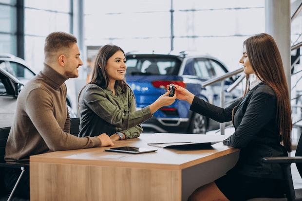 vendedora apresentando carro para casal